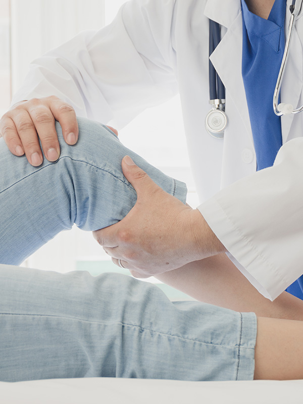 Doctor giving a patient a leg treatment