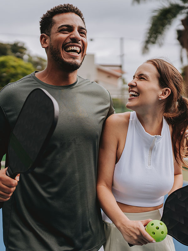 Couple playing pickleball celebrate point