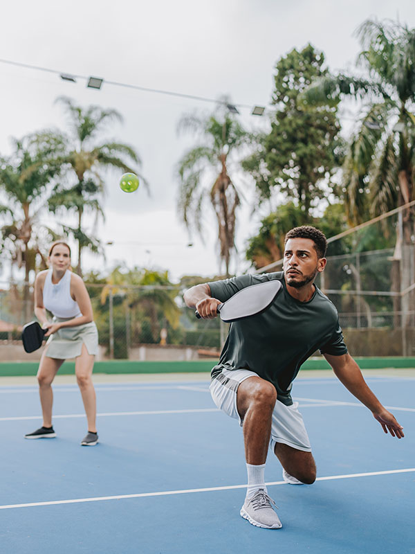 Two friends playing pickleball