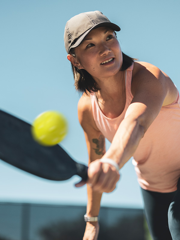 A woman having fun and playing pickleball