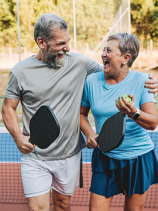 Senior couple playing pickleball
